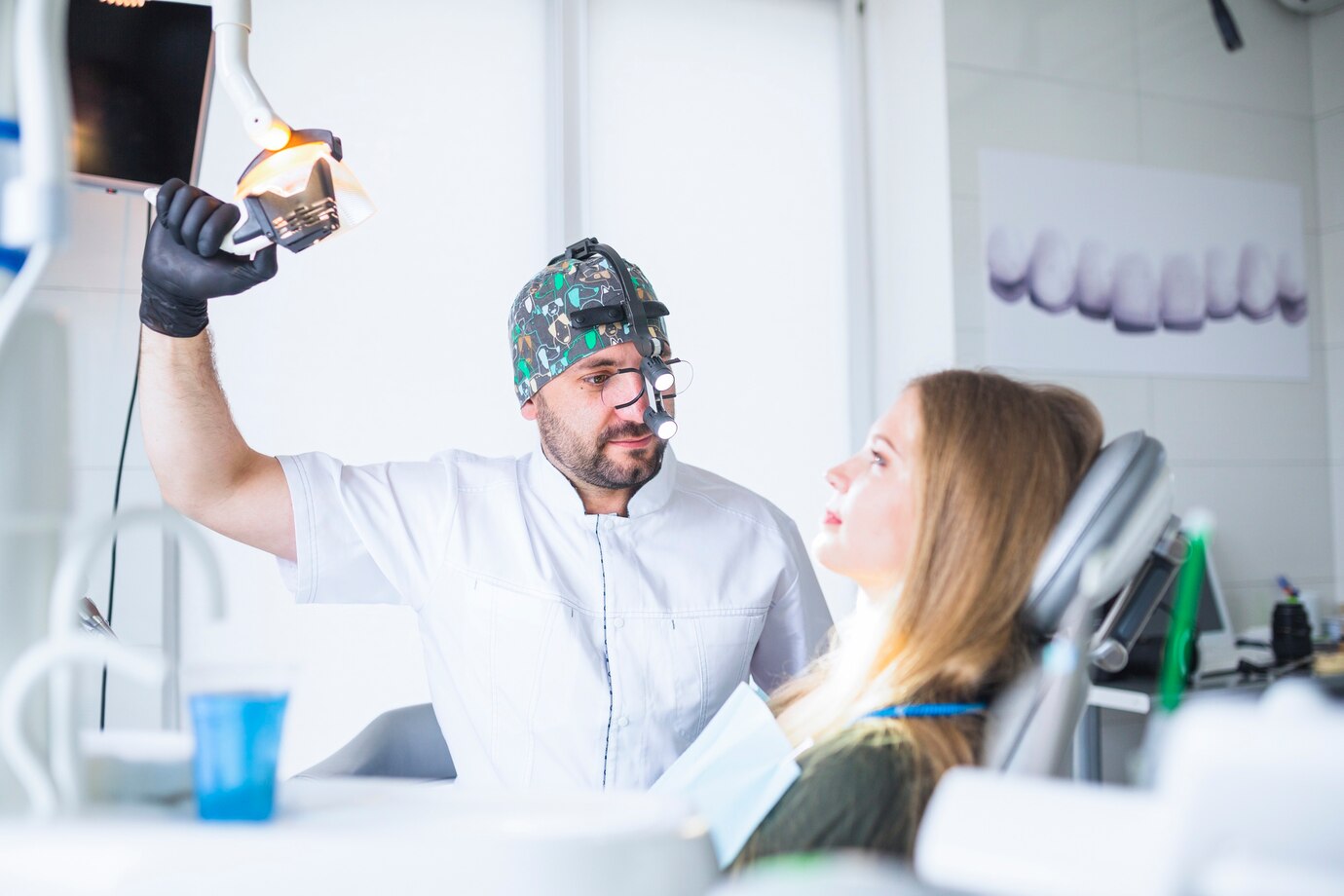 dentist-wearing-dental-loupe-binoculars-treating-female-patient_23-2147862070